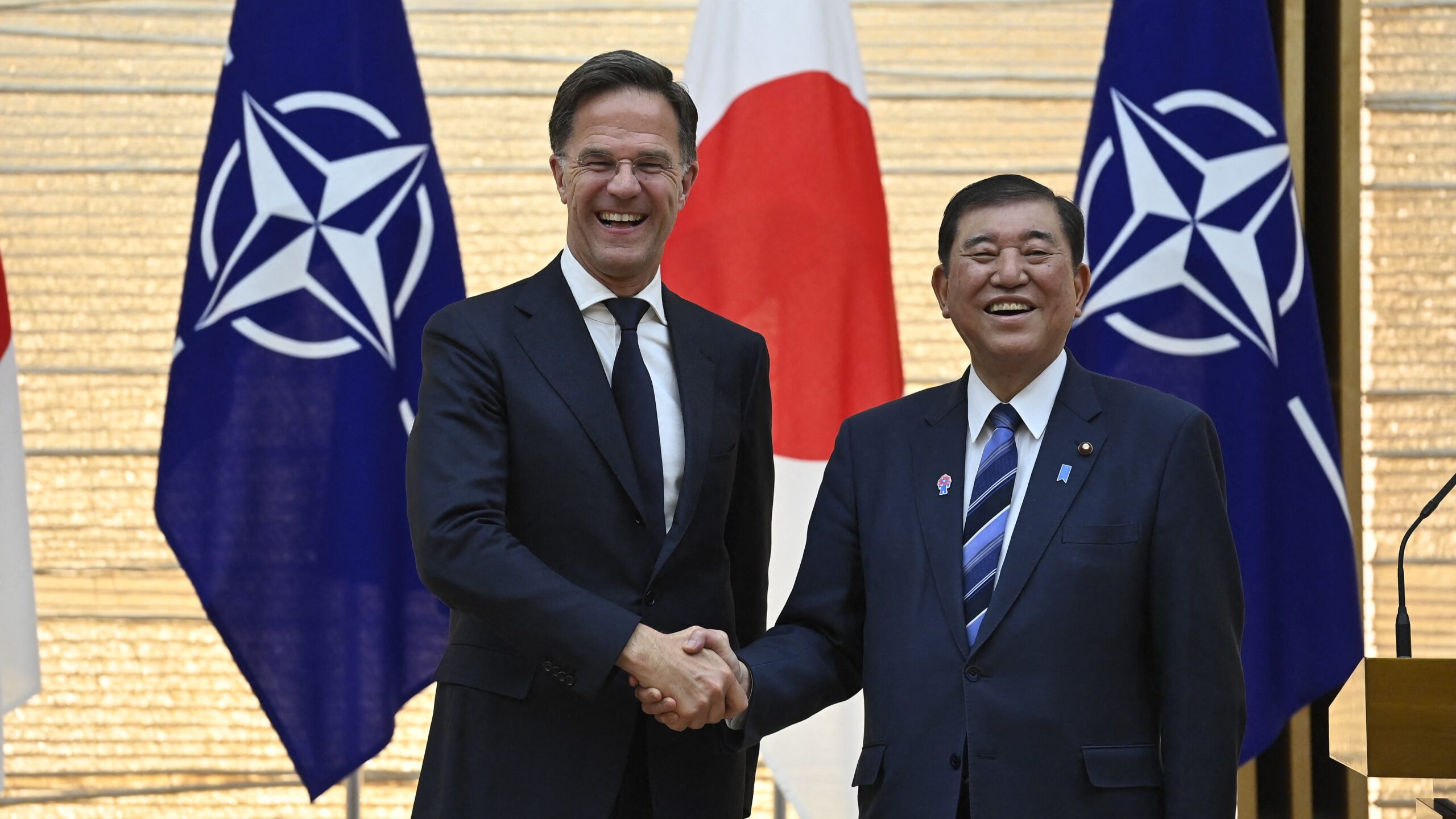 ATO Secretary General Mark Rutte (L) shakes hands with Japanese Prime Minister Ishiba Shigeru at the end of a join press conference after their meeting at the premier's office in Tokyo on April 9, 2025.